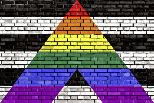 Straight Ally flag painted on brick wall
