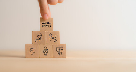 Values Driven Marketing Concept. Values driven marketing icons on wooden blocks representing...