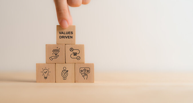 Values Driven Marketing Concept. Values driven marketing icons on wooden blocks representing customer centric strategies, business value creation and offering. Sustainable long term success strategy.