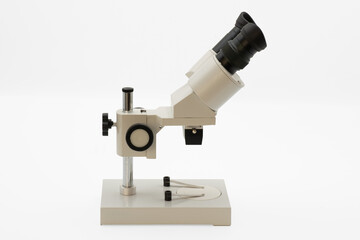 Optical microscope on a clean surface ready for scientific observation in a laboratory Isolated on white background