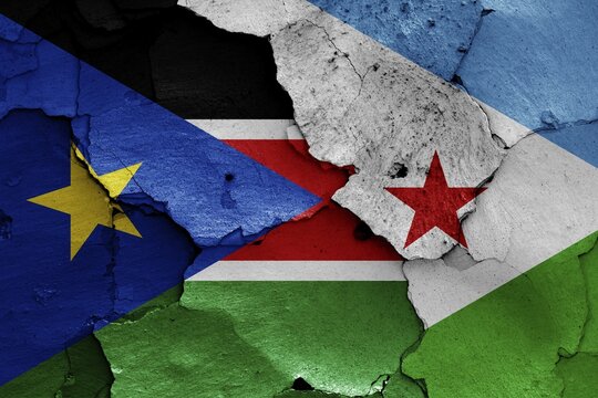 Flags of South Sudan and Djibouti painted on cracked wall