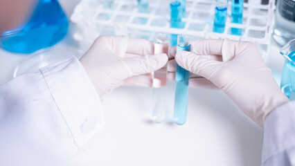 Scientist compare difference between two test tubes laboratory science research chemistry chemical