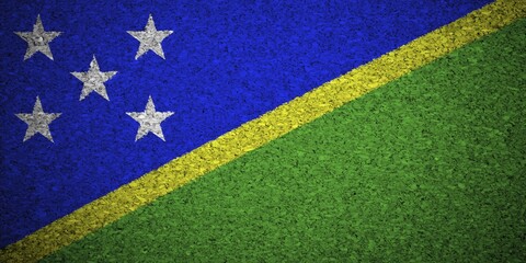 Fototapeta premium The Solomon Islands flag painted on a cork board