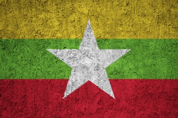 Myanmar flag painted on the cracked grunge concrete wall
