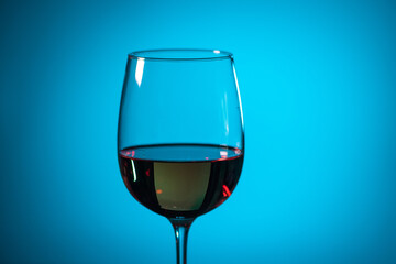 glass of pink wine on a colored background.