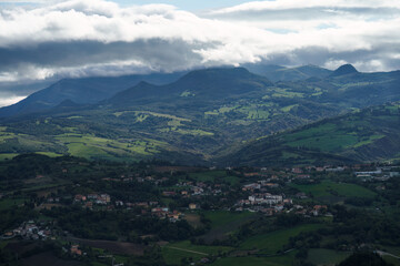 Fototapeta premium San Marino countryside with distant mountains under a cloudy sky