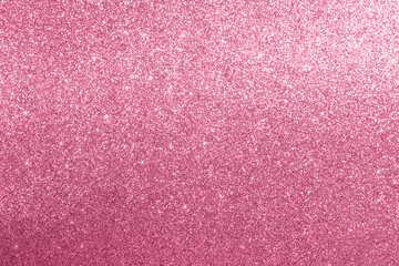 Pink glitter textured background with sparkling and shimmering effects under light