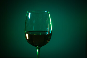 glass of pink wine on a colored background.
