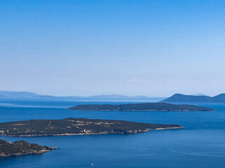 Waves gently kissing the sunlit coast. Concept of the peace, vacation dreams, and the untouched beauty of Greece.