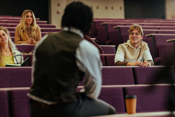Professor answering questions during lecture in university classroom