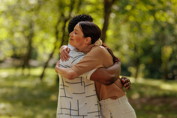 Couple hugging in a park on a summer day