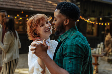 Couple dancing at an outdoor social event