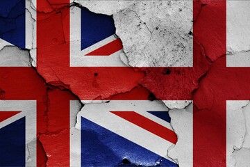 Fototapeta premium Flags of UK and England painted on cracked wall