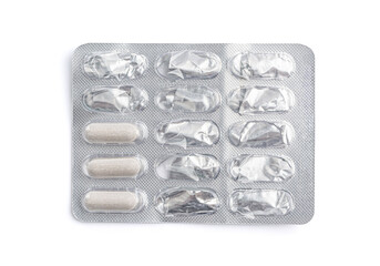 Used blister with pills on a white background.