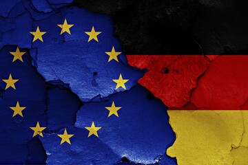 Flags of EU and Germany painted on cracked wall