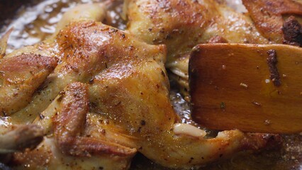 A mouthwatering image of juicy roasted chicken with a golden crispy skin, seasoned with aromatic spices, lying in a pan. The dish looks incredibly delicious, perfect for a family dinner or lunch.