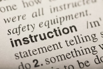 Obraz premium Instruction, word in dictionary. Macro shot. Selective focus