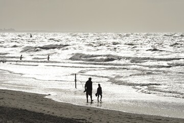 Man and child walking on the beach, backlight, Norderney, East Frisia, Lower Saxony, Germany, Europe