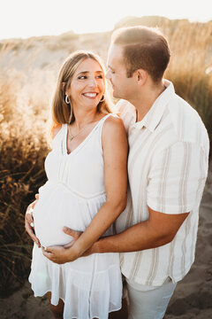 Young couple expecting pregnant woman husband wife smiling