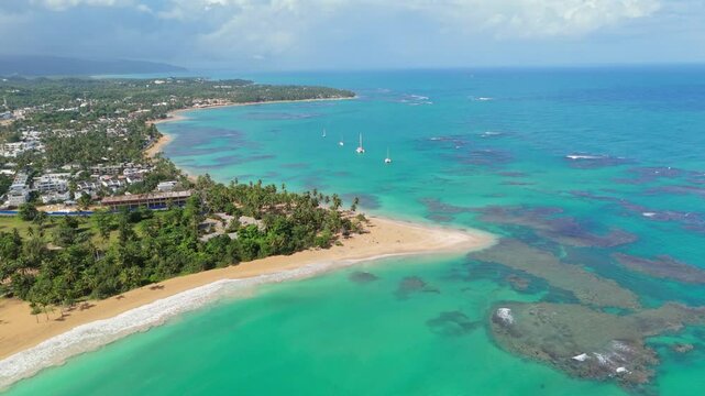 Backward shot at Punta Popy Beach, Las Terrenas, capturing the anchored boats and the stunning tropical landscape with the turquoise sea