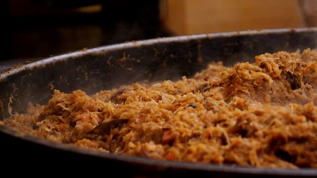 Polish dish - Bigos. Cabbage cooking in a large pot outdoors