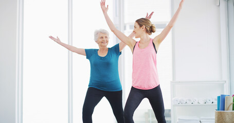 Yoga, senior woman and trainer for fitness, healthy body and smile for geriatric wellness. Stretching, pilates coach and exercise together for balance, holistic and help with physical therapy in gym