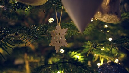Evergreen Christmas Tree Decorated with LED Lights Wooden Snowflake Ornament and Fragile Glass Baubles