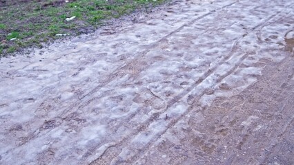 Pedestrian Shoeprints Footprints Left of Melting Winter Snow Slush Mud Covering Park Walkway