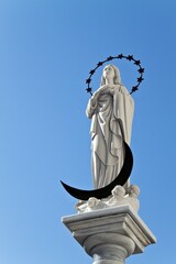 Statue of the Blessed Virgin Mary, Maria Virgen de Regla, on a sandstone church in the center of...