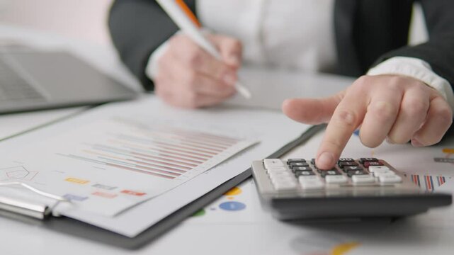 A highly skilled professional accountant diligently working to calculate important financial figures, utilizing various documents and data to ensure accuracy and reliability in their computations