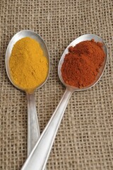 Spices on old spoons, curry and paprika powder
