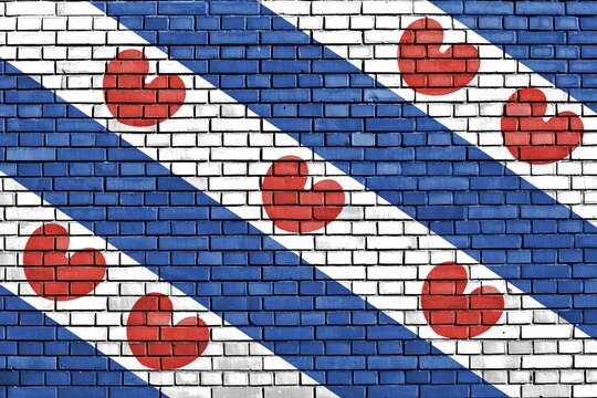 Flag of Friesland painted on brick wall