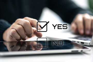Closeup image man hand select yes on check box. Choosing between option, positive decision concept