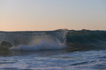 Wave breaking on the beach shore.