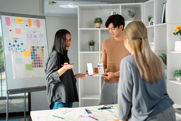 Team presenting UX UI designs with smartphone mockups and visuals.