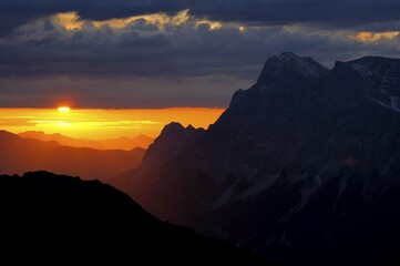 Sunrise behind Zugspitze Mountain with staggered mountain peaks, Berwang, Ausserfern, Tyrol, Austria, Europe