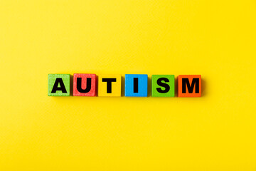 Autism awareness day.2 April world autism awareness day background.Design element.Care Awareness campaign for Autism.AUTISM text with colorful wooden puzzles, letters and cubes.Space for text.Top view
