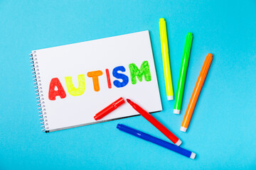 Autism awareness day.2 April world autism awareness day background.Design element.Care Awareness campaign for Autism.AUTISM text with colorful wooden puzzles, letters and cubes.Space for text.Top view