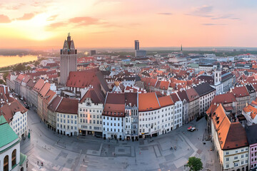 Obraz premium Picturesque European cityscape displays historic architecture with sunrise illuminating rooftops of the old town.
