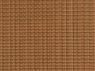 Close-up view of a textured brown woven fabric with a repeating geometric pattern beautifully and perfectly