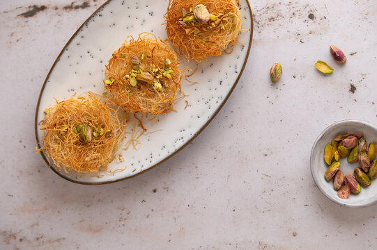 Snack made of Turkish Kadayif or Kataifi dough with pistachio and feta cheese filling. Savory Nest pastry. Close up. Turkish cuisine