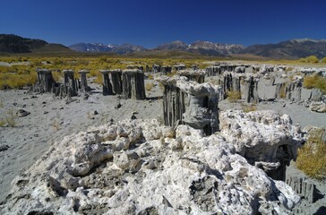 Tuff rock formations, cliffs at the edge of Mono Lake and the Sierra Nevada Mountains in the...