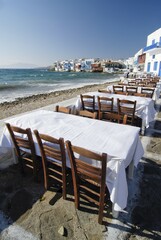 Tables at a restaurant on the waterfront located in front of Little Venice District in Mykonos, Cyclades, Greece, Europe