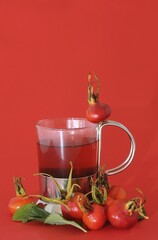 Glass with rose hip tea and rose hips