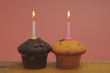 Two muffins with birthday candles