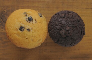 Two muffins on an old wooden board