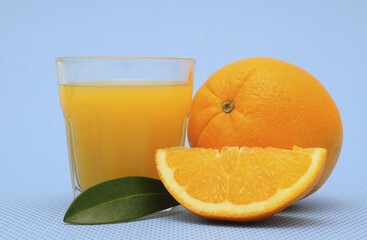 Freshly squeezed orange juice, an orange and an orange quarter