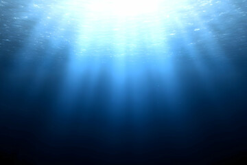 Sunlight penetrates deep blue ocean water, creating a tranquil and serene underwater scene.