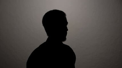 Man giving anonymous interview hiding identity. Portrait of unknown witness testifying to investigation.