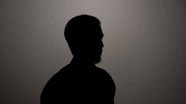 Man giving anonymous interview hiding identity. Portrait of unknown witness testifying to investigation.